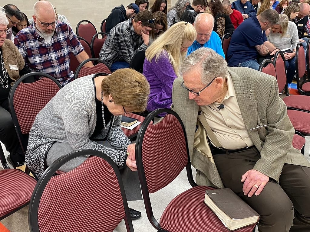 Dad and Mom praying at church