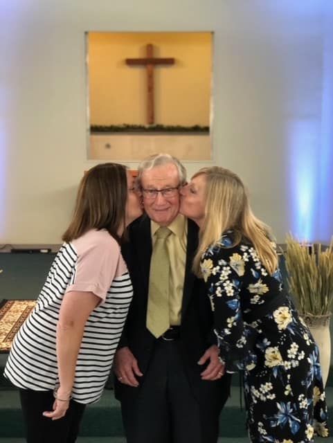 Dad gets kiss from his daughters